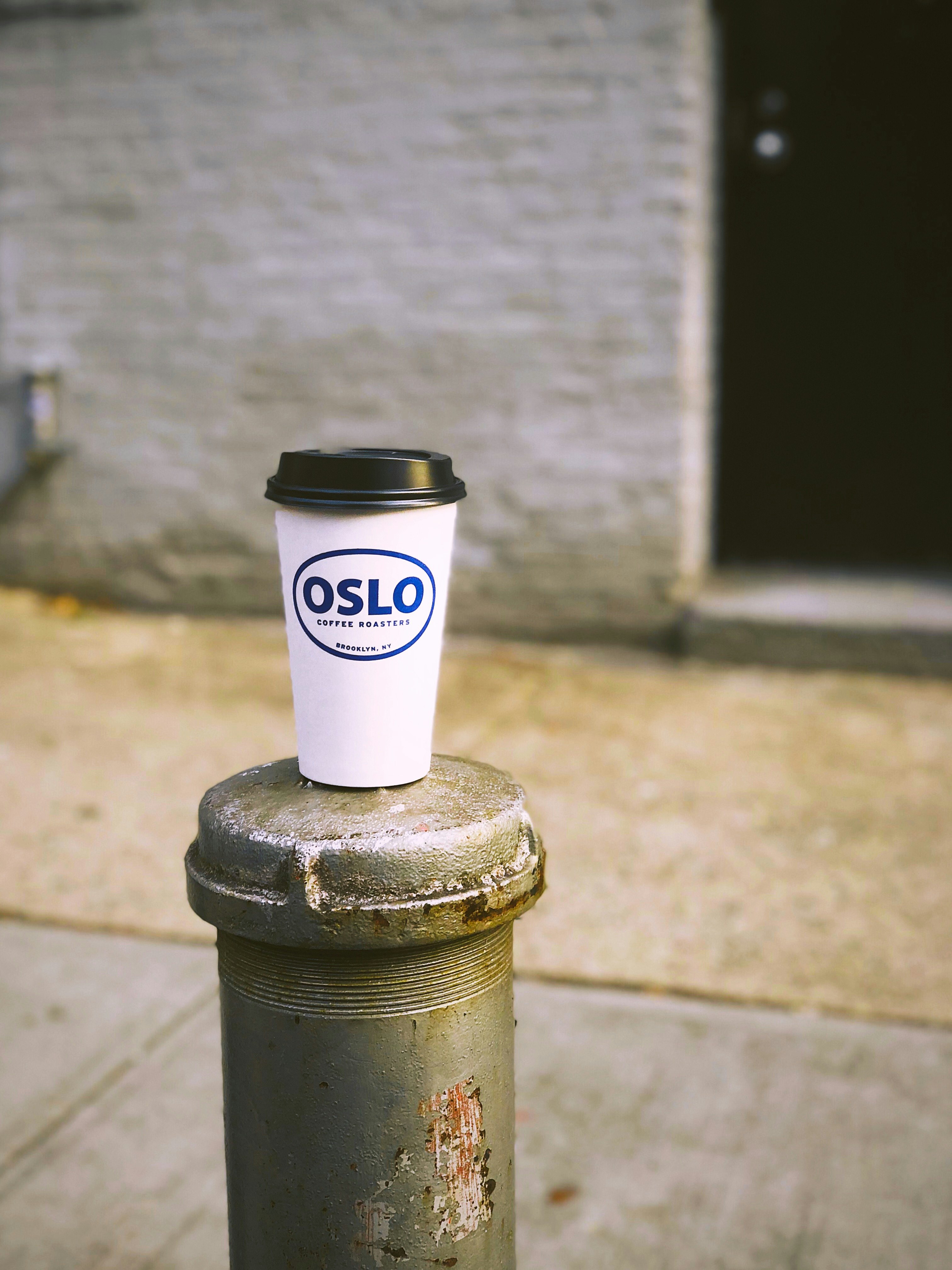 Oslo disposable cup on post near door